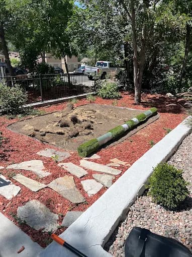 Flagstone walkway with mulch beds and fresh sod in Colorado Springs